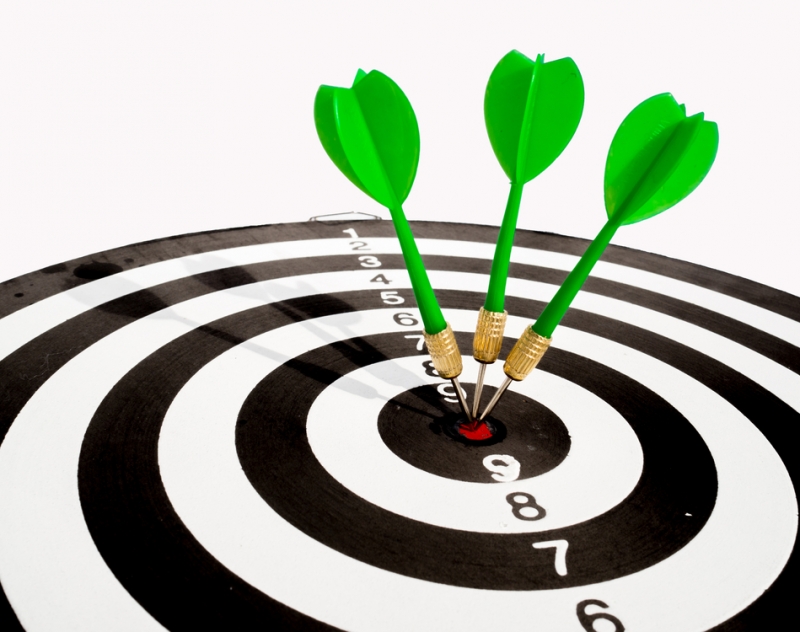 Target with three green dart focus on bull's eye, Setting challenging business goals And ready to achieve the goal with teamwork concept.